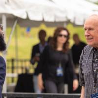 Two guests approaching each other at the Jamie Hosford Football Center dedication.